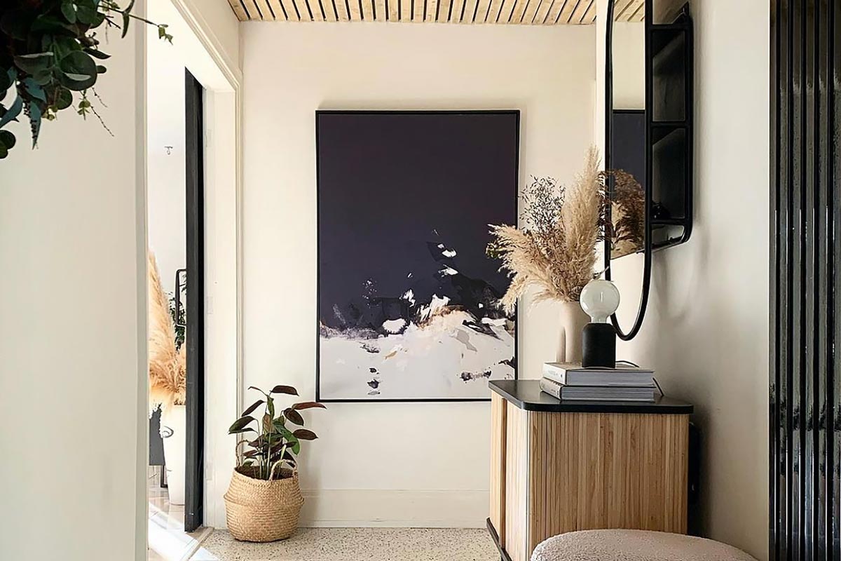Large abstract landscape canvas art in an organic japandi style hallway