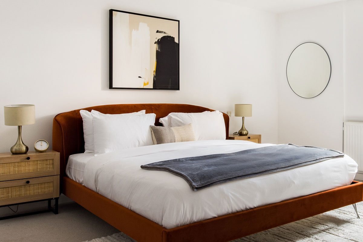 Square abstract canvas art above bed in modern bedroom