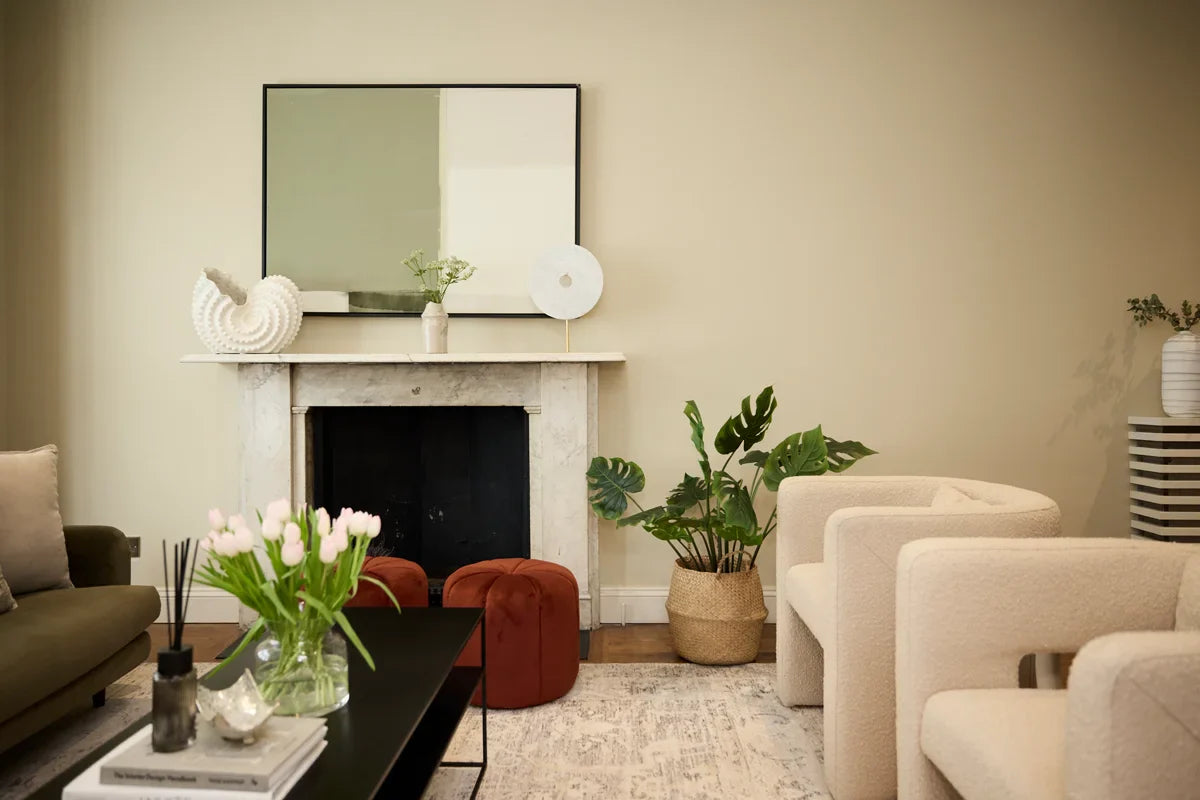 Down to earth, a minimal green and neutral abstract large canvas art pictured above a marble fireplace in a modern organic style living room