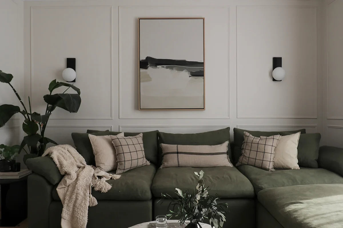 Soothe the soul, a neutral large abstract landscape pictured above a green sofa in a modern organic style living room