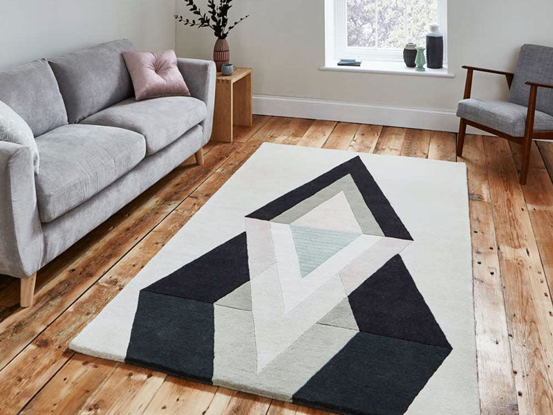 Abstract geometric style wool rug in neutral colours on wooden floor of scandi style living room
